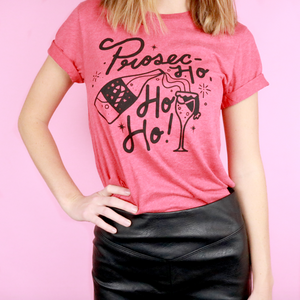 An image of the Prosec-Ho Ho Ho funny Christmas tee from Saturday Morning Pancakes styled with a black skirt.
