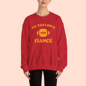 Red sweatshirt with yellow text and football graphic worn by a person on a white background