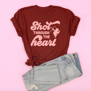 An image of the Shot Through the Heart Valentine's Day t-shirt with a pair of pants from Saturday Morning Pancakes.